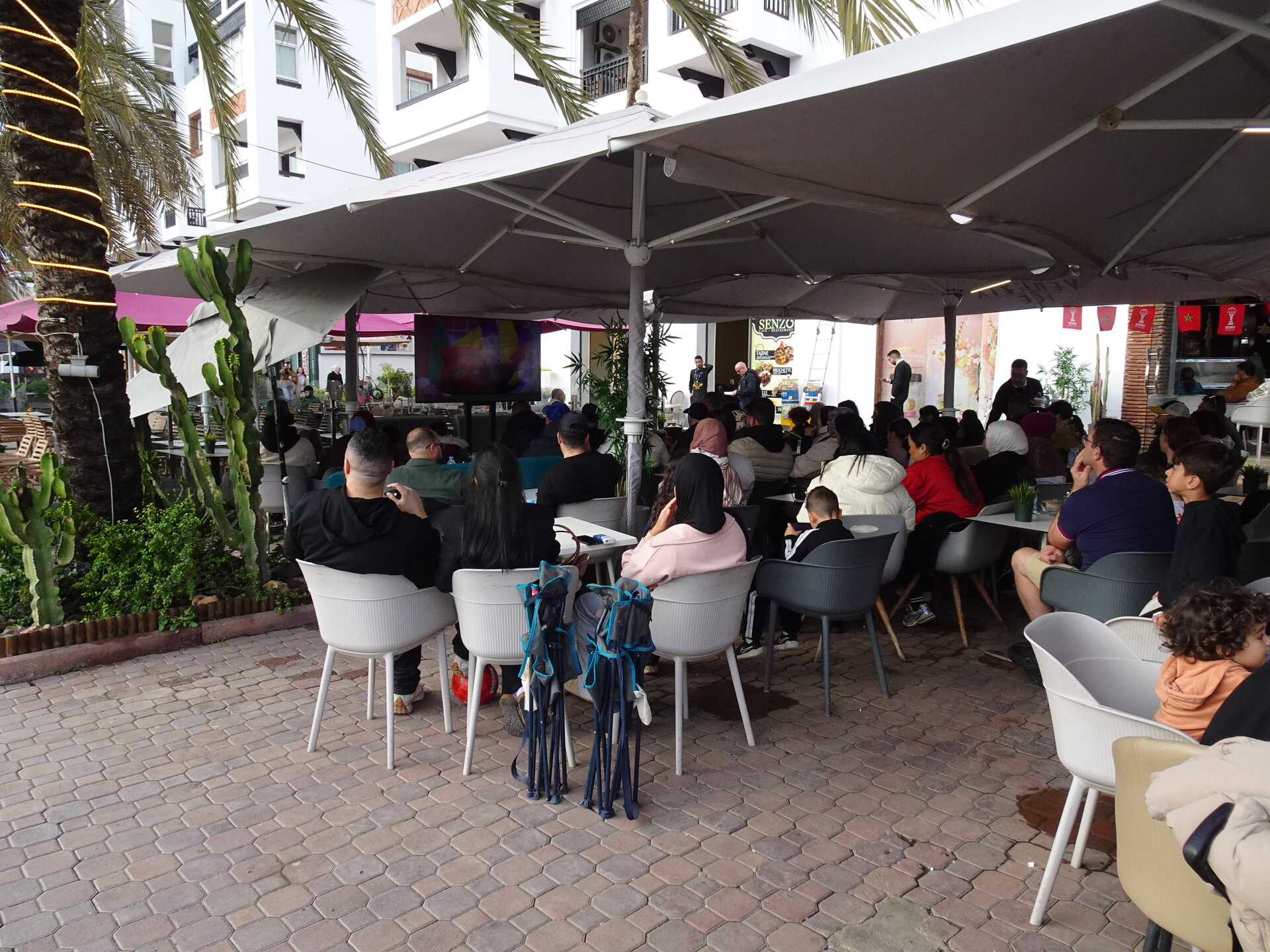 Cafe packed with people watching Morocco play in the AFCON group stage. Victory was followed by vuvuzelas, trumpets, and car horns along the beachfront.
