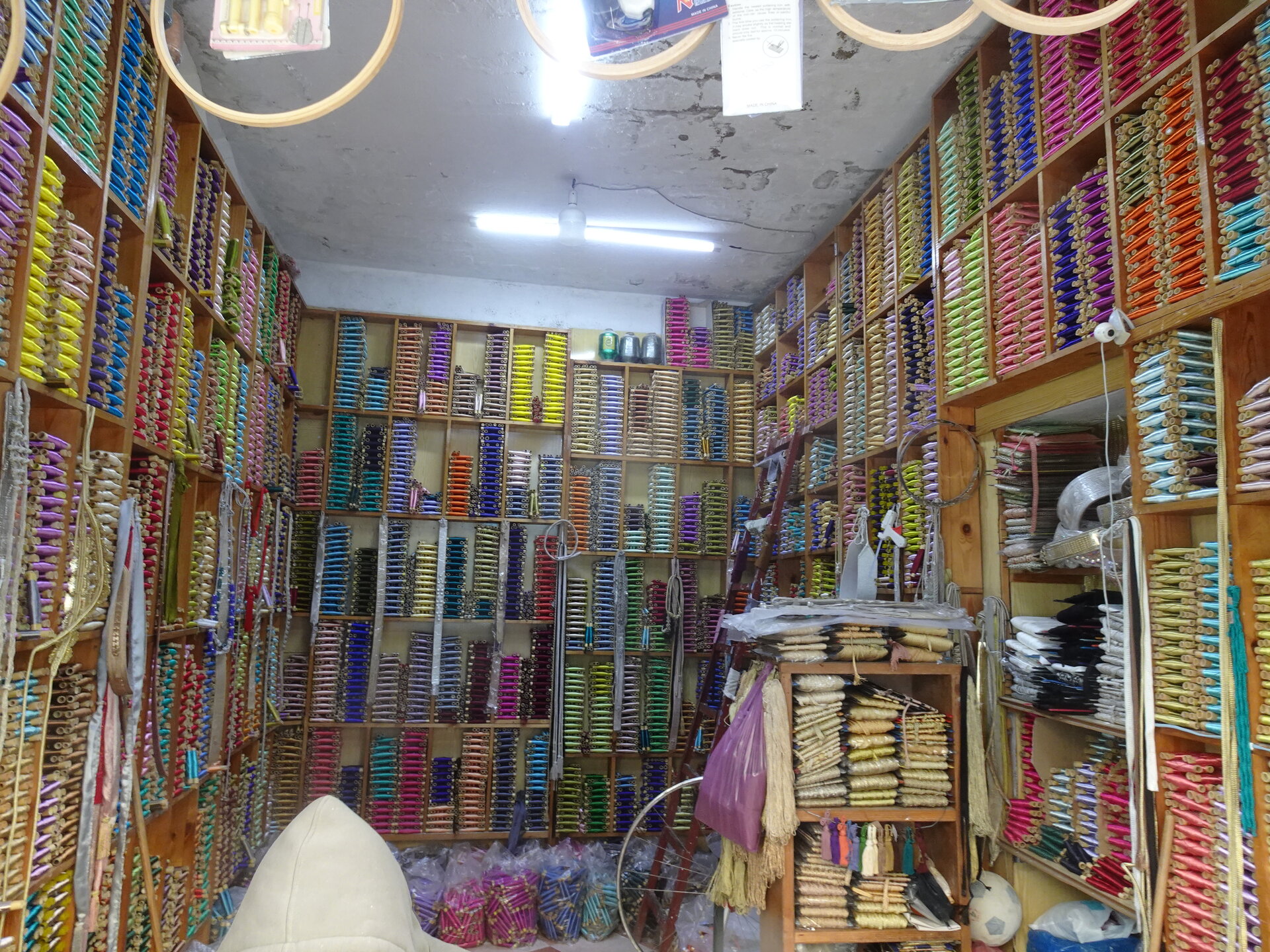 Small shop packed floor to ceiling with colourful thread spools