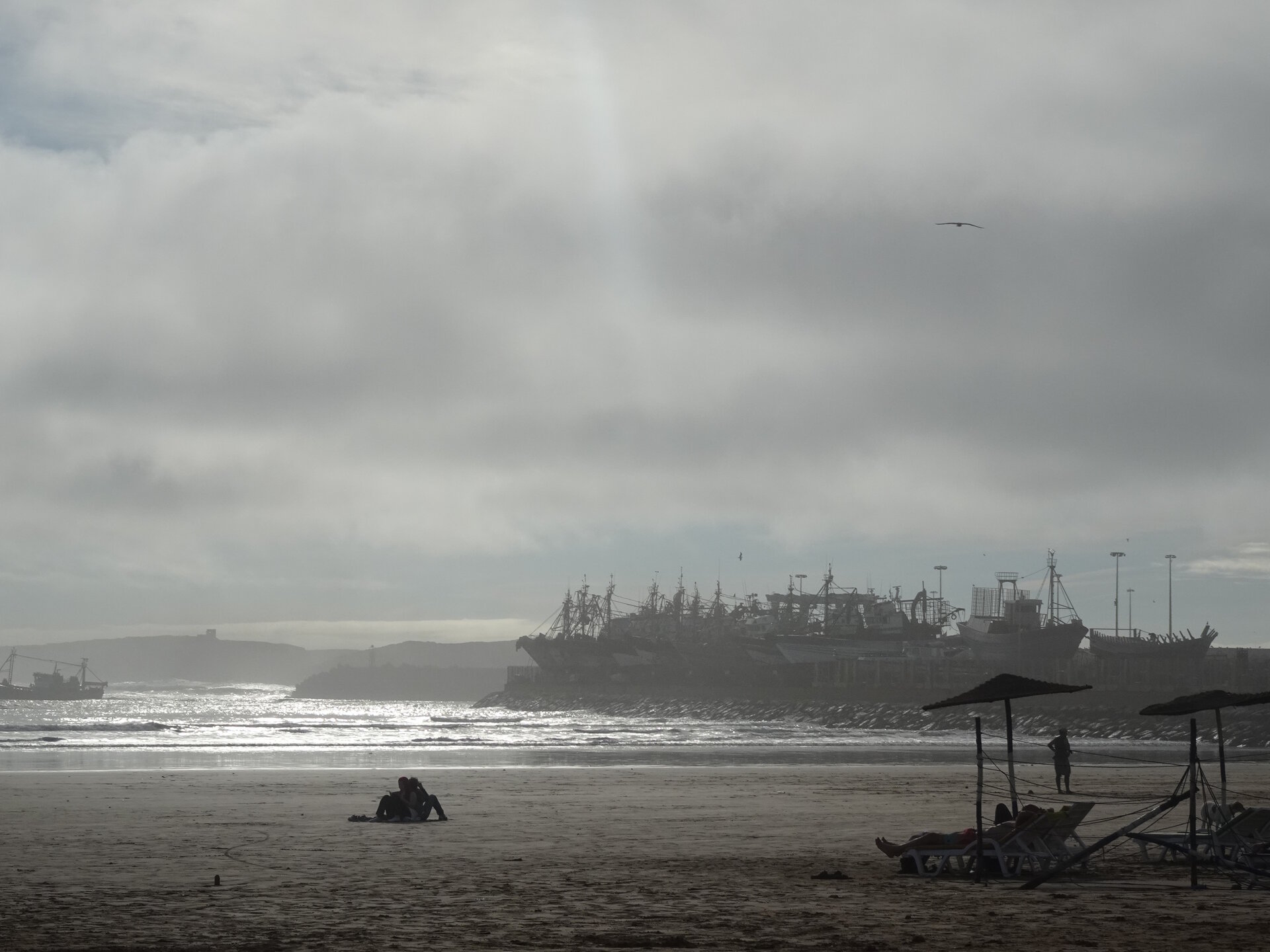 Beach with fishing boats in the background