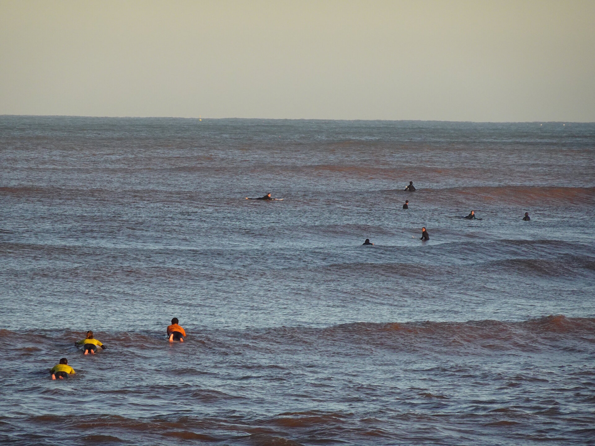 Surfers at sunset