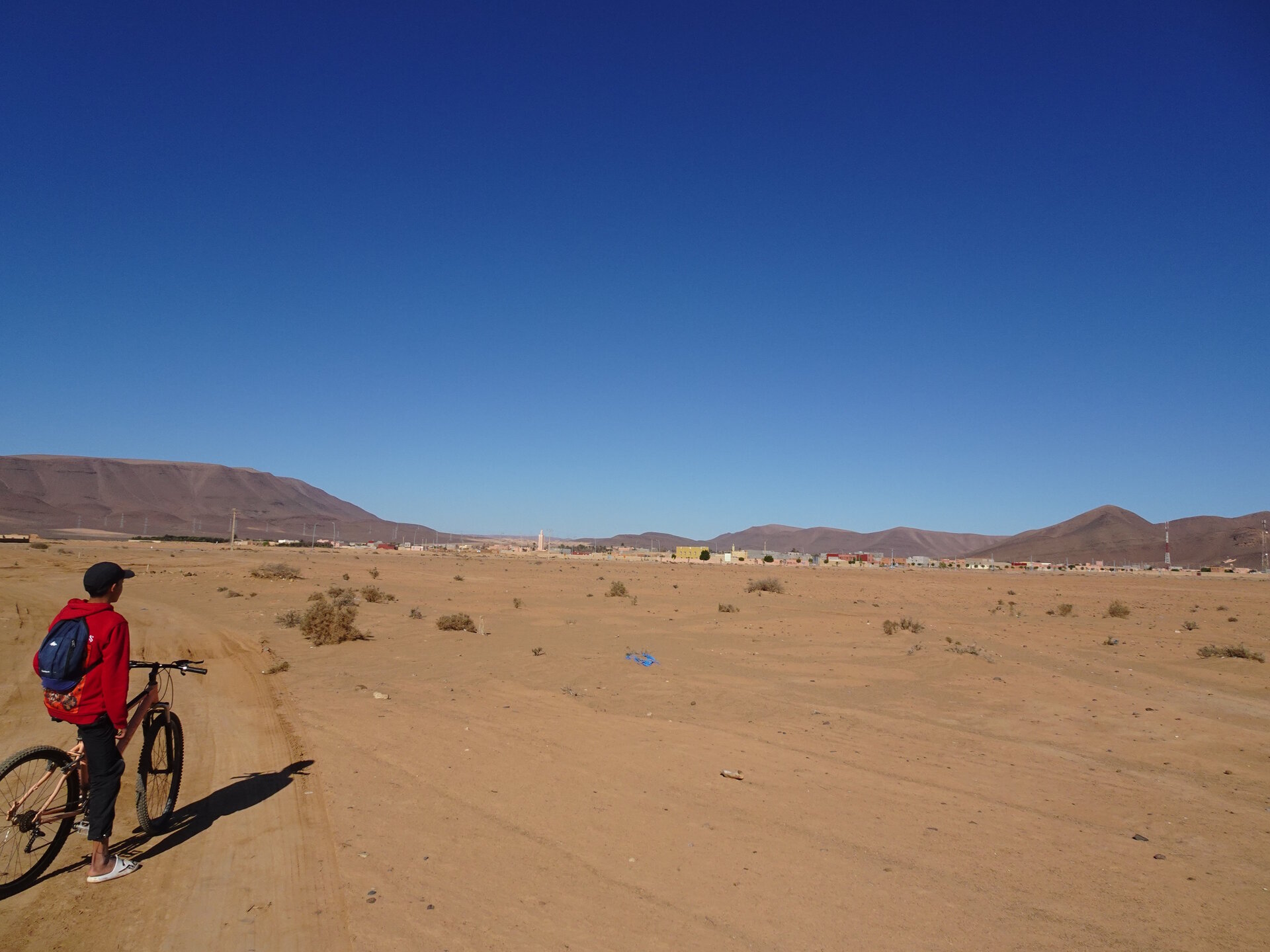 Faisal on a bike looking over Fask