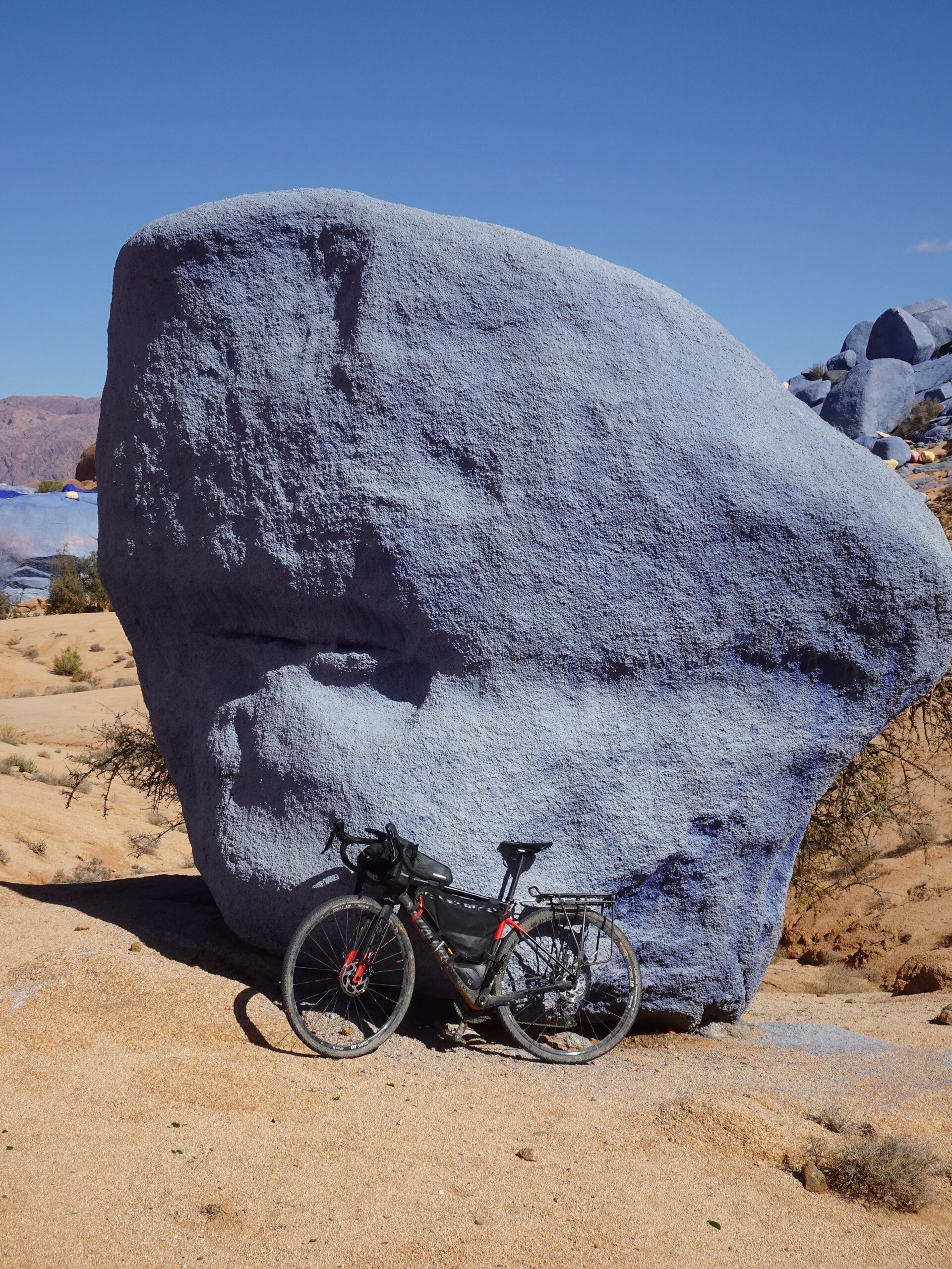 Bike in front of blue painted rocks