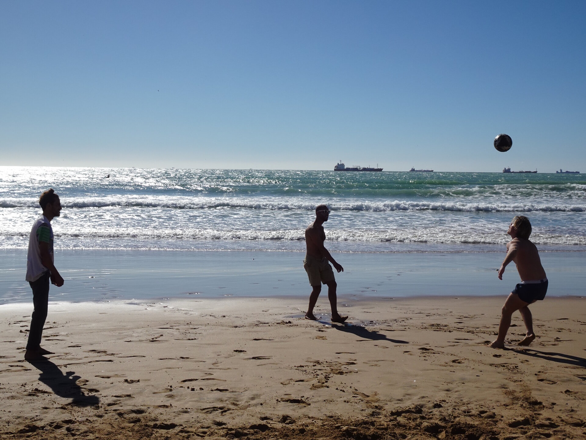 Playing football on the beach